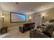 Home theater room with large screen, sconce lighting and comfortable reclining leather seats at 52 Innisbrook Ave, Las Vegas, NV 89113