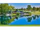 Scenic view of a pond with a cascading waterfall, lush landscaping and tranquil water at 52 Innisbrook Ave, Las Vegas, NV 89113