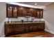 A classic style wet bar featuring custom cabinetry, granite countertop, and hardwood flooring at 52 Innisbrook Ave, Las Vegas, NV 89113