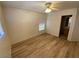 Comfortable bedroom features light, wood-look floors and a view into an attached bathroom at 5474 Jacobs Field St, Las Vegas, NV 89148