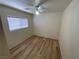 Cozy bedroom with window and wood-look flooring at 5474 Jacobs Field St, Las Vegas, NV 89148