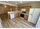 Kitchen features laminate countertops, wood cabinets, and is open to the living room at 5474 Jacobs Field St, Las Vegas, NV 89148