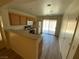 Kitchen features wood cabinets, laminate countertops, and access to the backyard at 5474 Jacobs Field St, Las Vegas, NV 89148