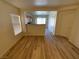 Living room boasts wood-look flooring and is open to the kitchen with a breakfast bar at 5474 Jacobs Field St, Las Vegas, NV 89148