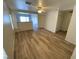 Bright living room boasts wood-look flooring and a view into an adjacent living space at 5474 Jacobs Field St, Las Vegas, NV 89148