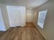 Living room showcases wood-look flooring, natural light, and views of the entry at 5474 Jacobs Field St, Las Vegas, NV 89148
