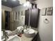 A well-lit bathroom with double sinks, granite countertops, and modern fixtures at 5804 Balzar Ave, Las Vegas, NV 89108
