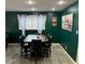 Dining area with a dark wood table with seating for six, next to the living room at 5804 Balzar Ave, Las Vegas, NV 89108