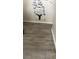 View of a home's hallway with grey wood-look floors and decorative wall art at 5804 Balzar Ave, Las Vegas, NV 89108