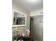 Hallway decor includes a decorative mirror and orchid plants on a small table at 5804 Balzar Ave, Las Vegas, NV 89108