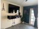 Living room with a large TV, media console, and view of the pool through the glass doors at 5804 Balzar Ave, Las Vegas, NV 89108