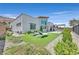 Beautiful backyard showcasing the home's exterior, landscaping, lawn, and outdoor living space at 6184 Willow Rock St, Las Vegas, NV 89135