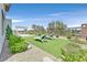 Landscaped backyard featuring manicured lawn, lounge chairs, and meticulously designed yard at 6184 Willow Rock St, Las Vegas, NV 89135
