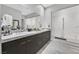 Modern bathroom featuring double sink vanity, sleek cabinets, and a glass-enclosed shower at 6184 Willow Rock St, Las Vegas, NV 89135