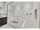 Bright bathroom showcasing a modern shower with bench and glass enclosure, and dual shower heads at 6184 Willow Rock St, Las Vegas, NV 89135