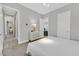 Bright bedroom features a white bedspread, dresser, and ensuite bathroom access at 6184 Willow Rock St, Las Vegas, NV 89135