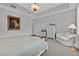 Spacious bedroom with a decorative light fixture, tall dresser, and an accent chair at 6184 Willow Rock St, Las Vegas, NV 89135
