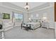 Serene bedroom featuring a tray ceiling, large window, and elegant furnishings at 6184 Willow Rock St, Las Vegas, NV 89135