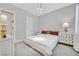 Cozy bedroom featuring neutral colors and a view into the ensuite bathroom at 6184 Willow Rock St, Las Vegas, NV 89135