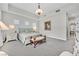 Large bedroom features a decorative chandelier, bench, and tray ceiling at 6184 Willow Rock St, Las Vegas, NV 89135