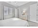 Bright bedroom with neutral colors, a ceiling light, and a large window at 6184 Willow Rock St, Las Vegas, NV 89135