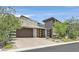 Stunning exterior featuring a modern design, beautiful stone accents, and a paved driveway at 6184 Willow Rock St, Las Vegas, NV 89135