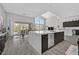 Bright kitchen with a center island, modern appliances, and a view to the outdoor patio at 6184 Willow Rock St, Las Vegas, NV 89135