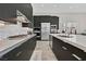 Modern kitchen with stainless steel appliances, sleek cabinetry, and a spacious island at 6184 Willow Rock St, Las Vegas, NV 89135