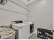 Convenient laundry area features a washer, dryer, shelving, and storage space at 6184 Willow Rock St, Las Vegas, NV 89135