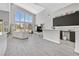 Open-concept living area with a bar, kitchen, high ceilings, and lots of light at 6184 Willow Rock St, Las Vegas, NV 89135