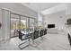 Open concept dining and living area with glass doors leading to outdoor space at 6184 Willow Rock St, Las Vegas, NV 89135