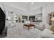 Open-concept living area with hardwood floors, modern furnishings, and abundant natural light at 6184 Willow Rock St, Las Vegas, NV 89135