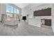 Bright living room with high ceilings, bar area, and wood look tile flooring at 6184 Willow Rock St, Las Vegas, NV 89135