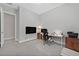 Well-lit office area with a desk, printer, wall-mounted television, and carpeting at 6184 Willow Rock St, Las Vegas, NV 89135