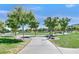 Lush green lawns and walking paths enhance the Oak Leaf Park experience for community residents at 6184 Willow Rock St, Las Vegas, NV 89135