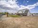 Wide-angle view of the property featuring a spacious yard with a patio, fire pit, and potential for customization at 6235 Westwind Rd, Las Vegas, NV 89118
