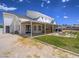 Expansive backyard features a covered patio, fire pit, lush lawn, and ample space for outdoor entertainment at 6235 Westwind Rd, Las Vegas, NV 89118
