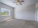 Spacious bedroom with a ceiling fan and a large window overlooking the exterior at 6235 Westwind Rd, Las Vegas, NV 89118