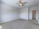 Bedroom features a ceiling fan, neutral carpet, and closet with doors at 6235 Westwind Rd, Las Vegas, NV 89118