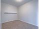 Empty bedroom with carpet, base trim, and an open closet with a shelf at 6235 Westwind Rd, Las Vegas, NV 89118