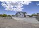 Striking exterior showcasing the home's architecture, driveway, and expansive lot at 6235 Westwind Rd, Las Vegas, NV 89118