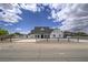Beautiful two-story home with lush landscaping and a sprawling front yard at 6235 Westwind Rd, Las Vegas, NV 89118