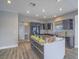 Spacious kitchen with stainless steel island, stylish cabinetry, and eat-in bar area at 6235 Westwind Rd, Las Vegas, NV 89118