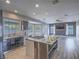 Modern kitchen with stainless steel island, dark cabinets, and open layout to the living area at 6235 Westwind Rd, Las Vegas, NV 89118