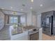 Modern kitchen features stainless steel island cooktop and appliances, connecting to a bright living space at 6235 Westwind Rd, Las Vegas, NV 89118