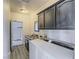 Bright laundry room boasts modern appliances, ample storage cabinets, and convenient sink with wood look flooring at 6235 Westwind Rd, Las Vegas, NV 89118