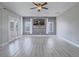 Spacious living room with light gray flooring, ceiling fan and access to outdoor patio at 6235 Westwind Rd, Las Vegas, NV 89118