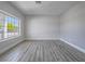 Bright and spacious living room with a large window, neutral colors, and ample natural light at 6235 Westwind Rd, Las Vegas, NV 89118