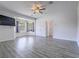 Spacious main bedroom featuring light gray flooring, a ceiling fan and views of the backyard at 6235 Westwind Rd, Las Vegas, NV 89118