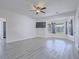 Airy main bedroom with light gray floors, ceiling fan, TV, and backyard views at 6235 Westwind Rd, Las Vegas, NV 89118